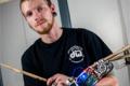 The robotic arm helps the person who loses his hand to play the drums