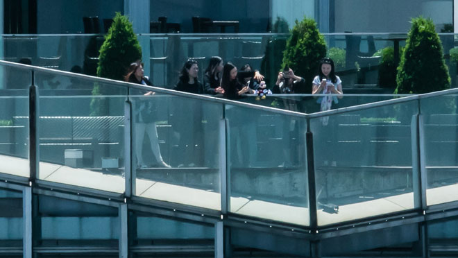 Picture 7 of A picture of the whole city of Shanghai, zoomed to the pedestrian's face