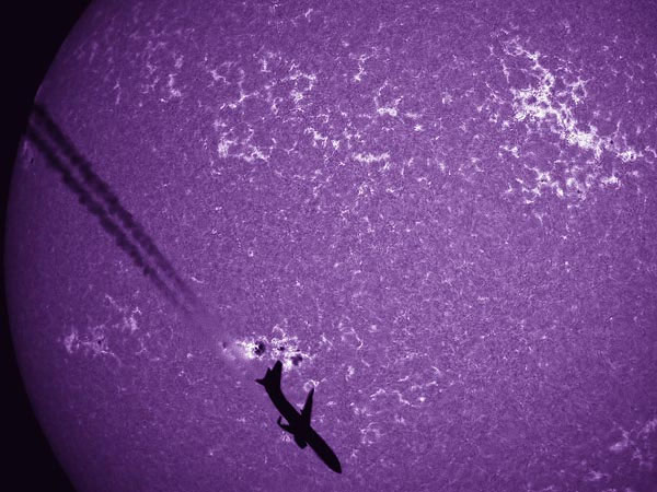 Picture 6 of Aerial photo: Boeing 737 silhouetted against the Sun.