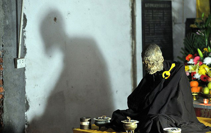 Picture 4 of Close up of mummy monks meditating in flower position