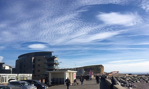Picture 1 of Cloud hole resembles two flying saucers in the English sky