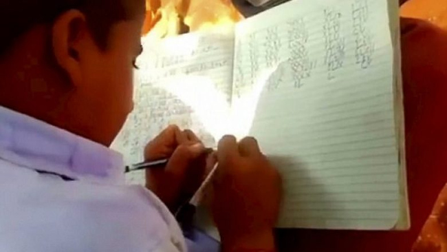 Picture 1 of Strangely, the school has all students writing with two hands