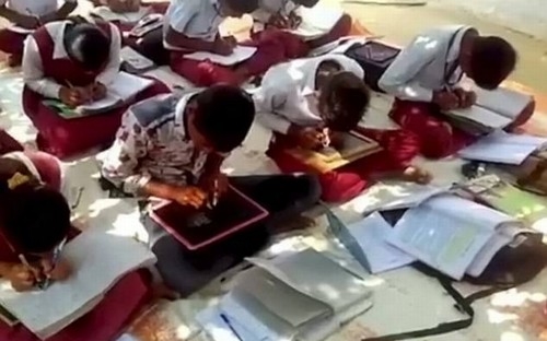 Picture 2 of Strangely, the school has all students writing with two hands