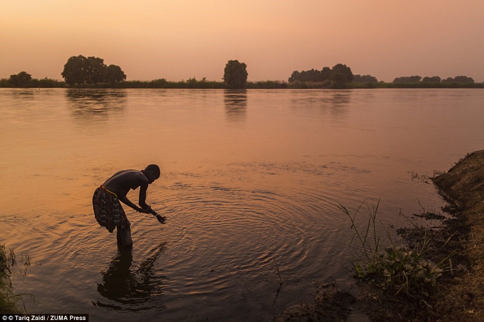 Picture 10 of The tribe washes their hair with cows' urine, uses manure to make medicine