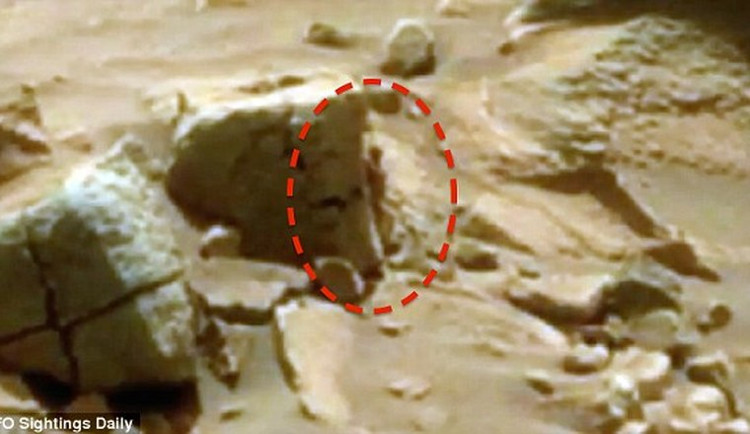 Picture 1 of 'Woman' hides behind a rock on Mars