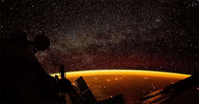 Picture 1 of Yellow halo like honey covered Earth in ISS image