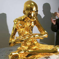 Chinese living mummy Buddha becomes a golden statue before entering the temple