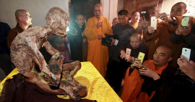Close up of mummy monks meditating in flower position