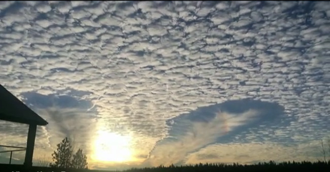 Cloud hole resembles two flying saucers in the English sky