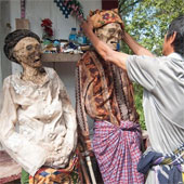 Continuously dig graves, wear new clothes and process dead people around the village