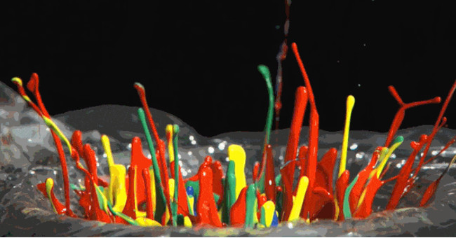 Dance screen of colorful paint drops under slow-motion view