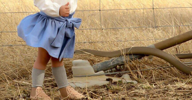 Death lurking at the foot of the little girl posing for pictures