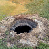 Explain the cause of the formation of a mysterious giant crater in Siberia