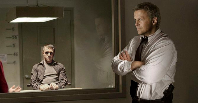 How does the double-sided mirror in the interrogation rooms work?