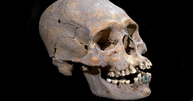 Long skulls like aliens encrusted with gems in their teeth