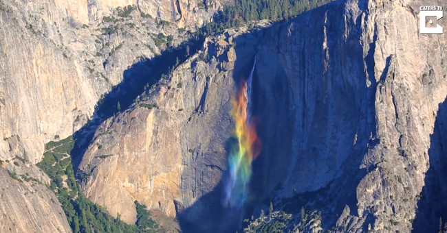 Rainbow waterfall flows along the cliff at an altitude of over 400 meters