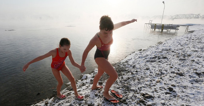 Siberian people bathing in cold water in the middle of the sky