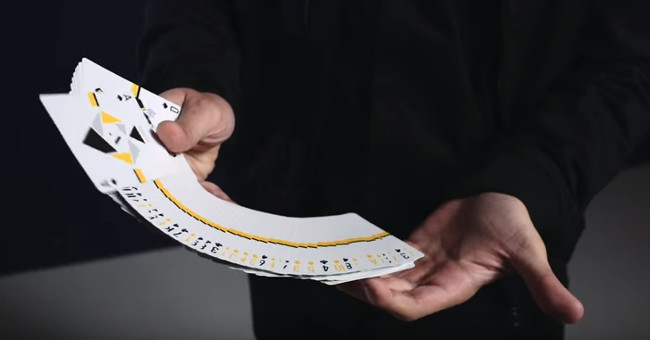 Slow motion videos perform tricks with cards