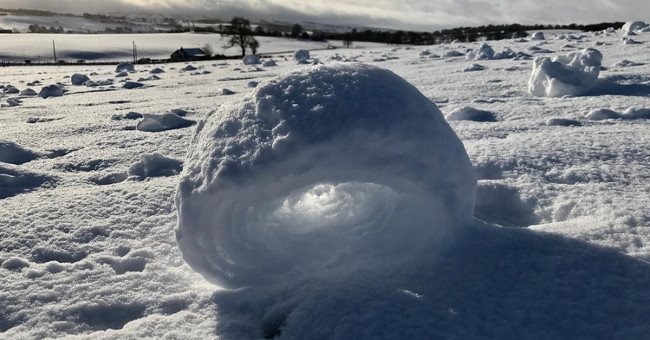 Snow cubes curled between Scottish fields
