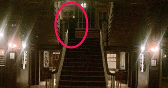 Specialist explaining the image of the ghost at the American hotel