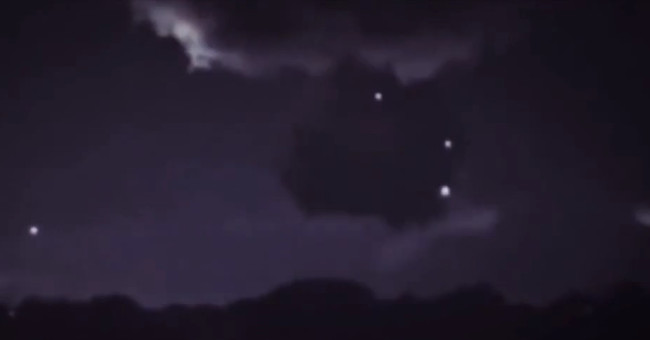 Spotlight next to a cloud of suspicious UFOs collecting storm energy