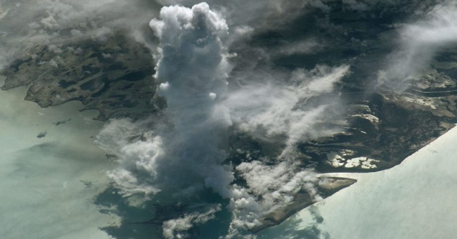 Stands of clouds stand like watchtowers from the universe