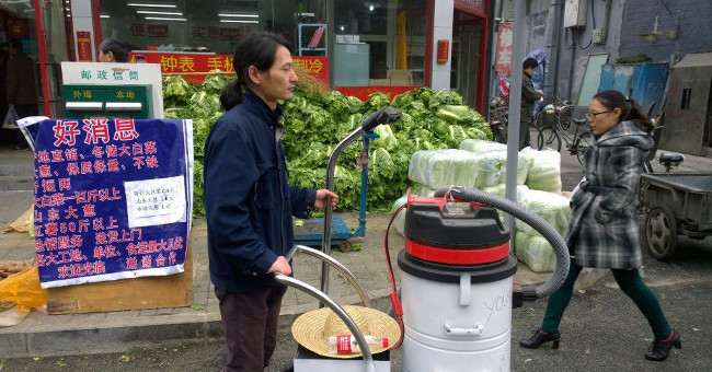 Street artist with brick dust pollution in Beijing