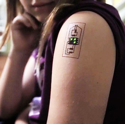 Tattoos electrical circuits on the skin to form sensors that monitor temperature and blood pressure