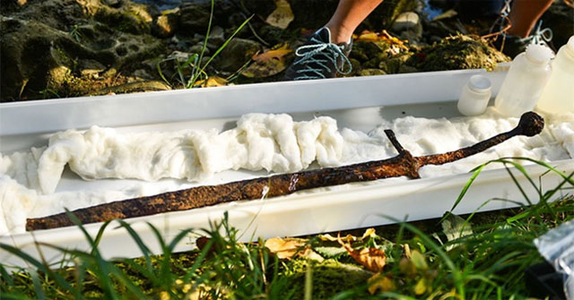 The 700-year-old sword is embedded in the rock at the bottom of the lake