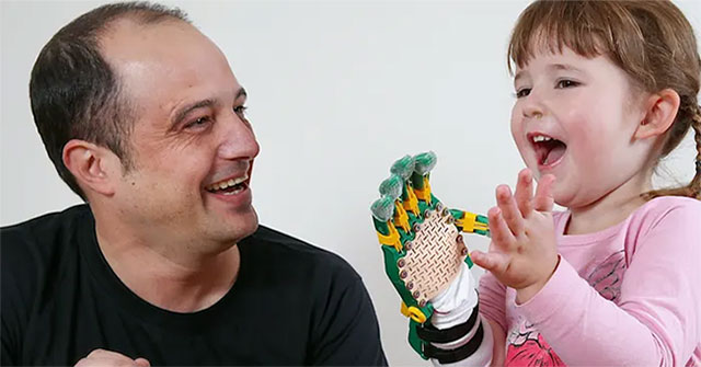 The engineer brings his hands to the disabled children