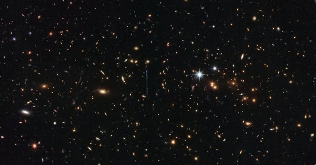 The galaxy cluster has three million billion times the mass of the Sun.