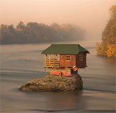 The house is in the middle of the river
