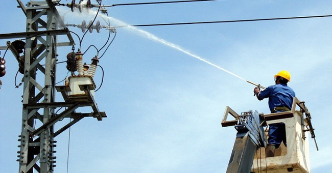 The image of electrician EVN cleaning the power line with high pressure water
