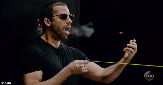 The magic magician catches the bullet flying by mouth