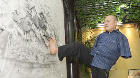 The man paints with his legs and mouth