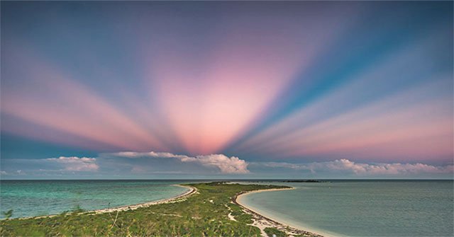The reverse sunset beam 'dyes' the pink sky