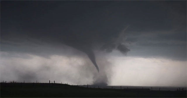 The storm hunting group standing in the middle of the tornado is forming in the United States
