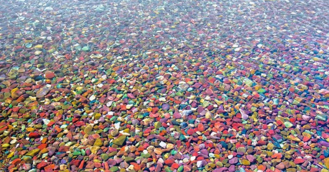 The strange lake contains millions of rainbow-colored stones