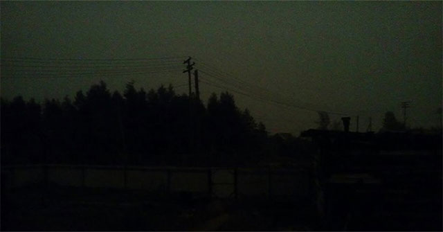 Where people live with the scene of dark sky in the middle of the day