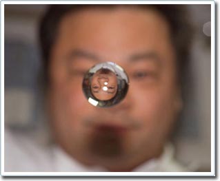 Why are water droplets spherical in the universe?