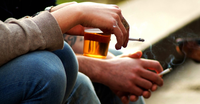 Why do alcoholics often smoke?
