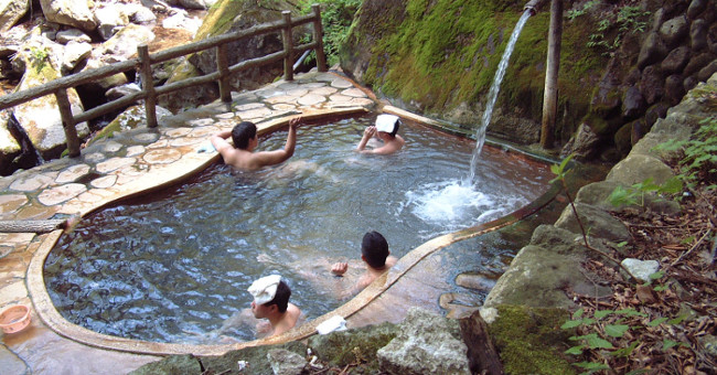 Why do Japanese people wear a small towel every time they bathe in 'hot springs'?