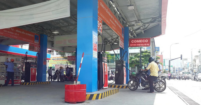 Why do people often place large sand bins at gas pump posts?