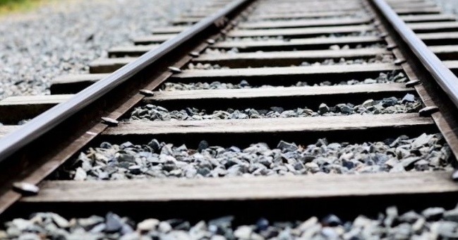Why do people spread stones along railroad tracks?