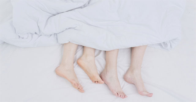 Why does putting your feet out of the blanket help you sleep better?