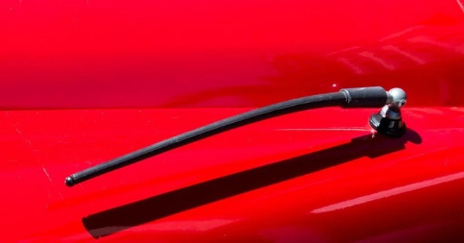 Why should I plug in a headset to hear the FM radio on my phone?