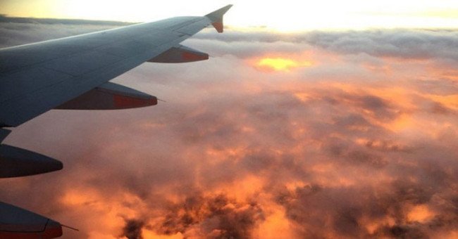 Why should you apply sunscreen even when flying?