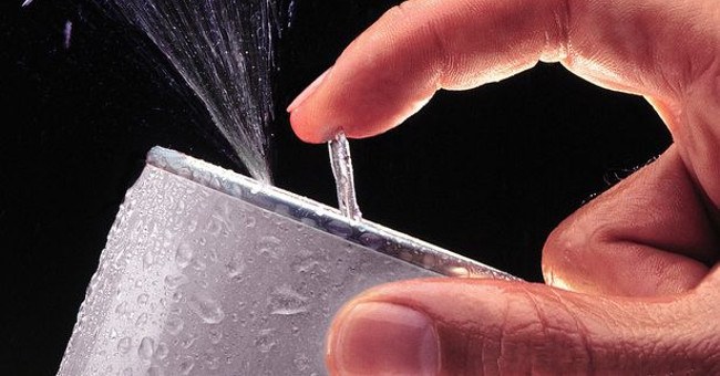 Why should you tap on the carbonated can before opening the lid