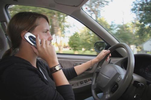 Why shouldn't a mobile phone be used while driving?