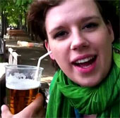 Woman drinking beer by ear